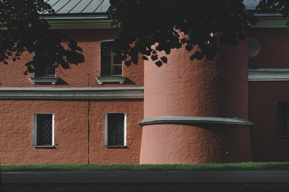 brown brick building with green trees