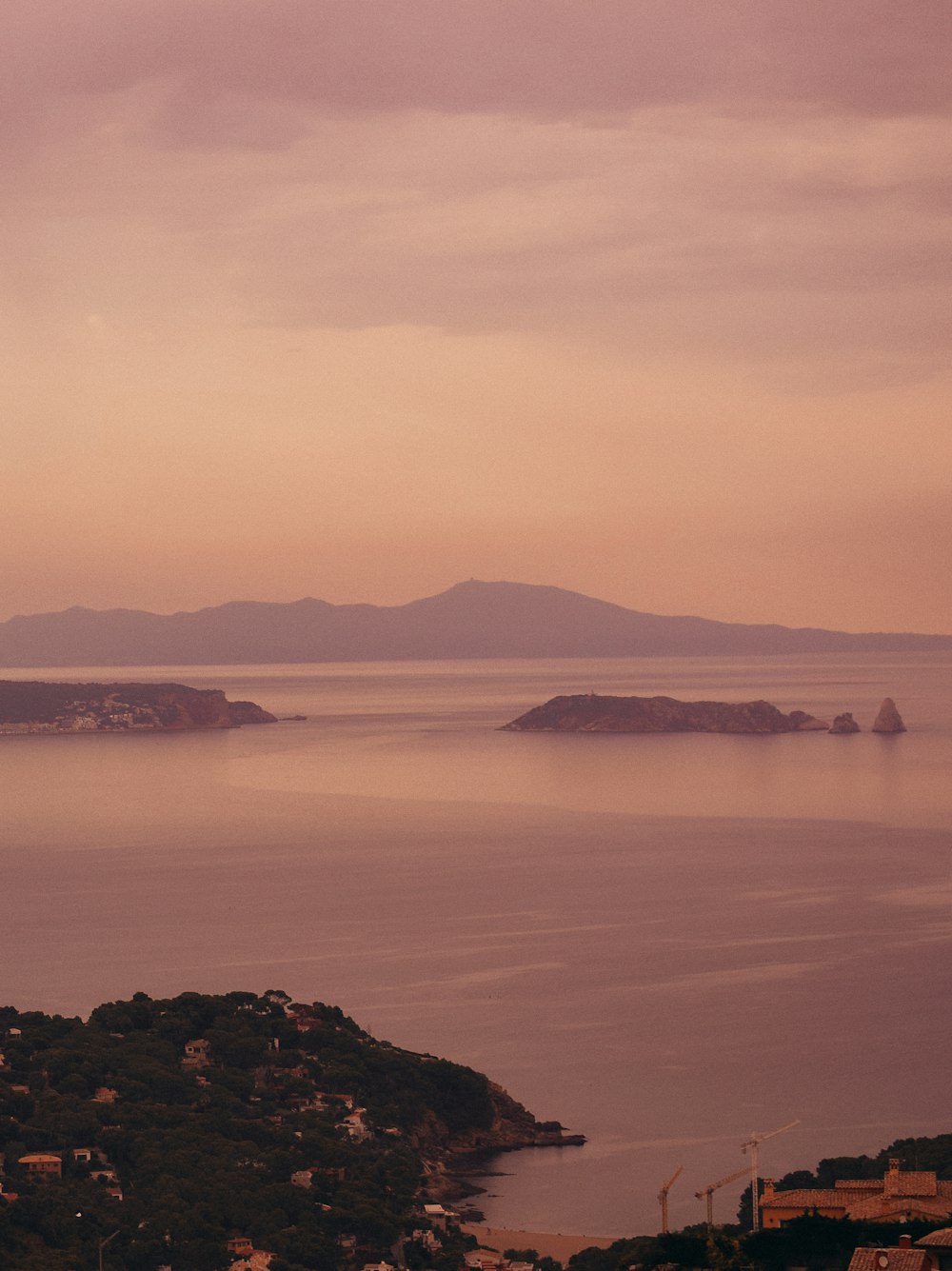 body of water near mountain during daytime