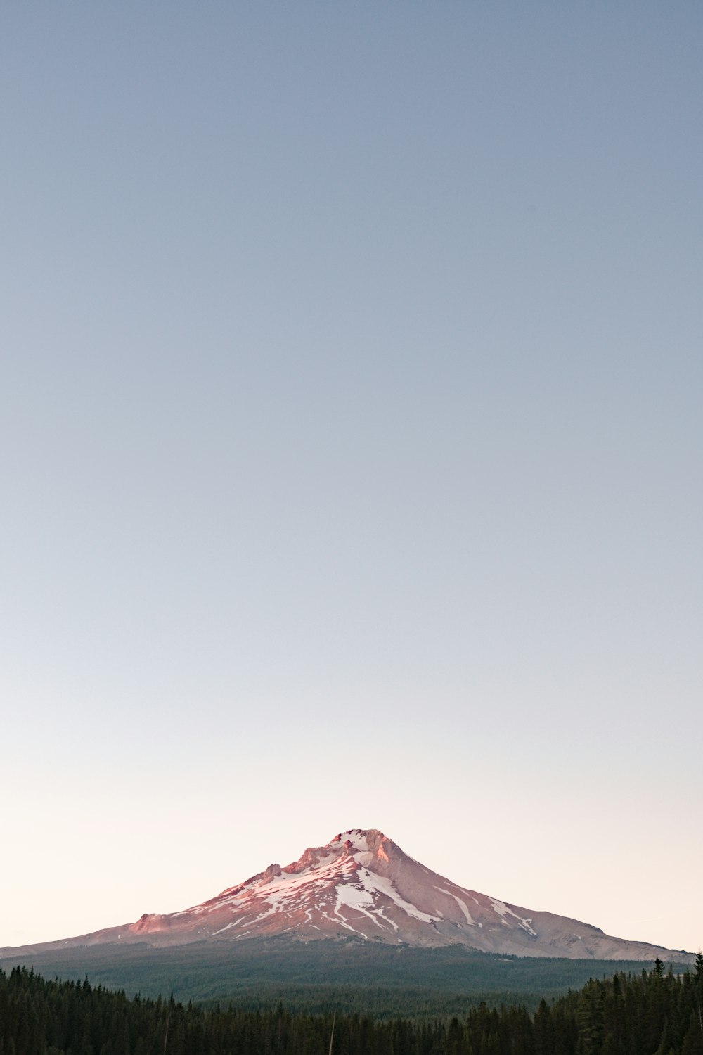 brown mountain under gray sky