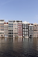 brown and white concrete building beside body of water during daytime