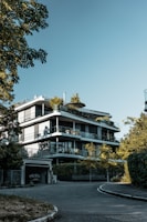 A modern glassy residential building in Cartagena with lush green surroundings.