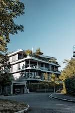 Close-up of Arihant Seasons’ modern architecture blending with lush greenery.