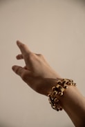 person wearing silver beaded bracelet