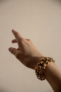 person wearing silver beaded bracelet