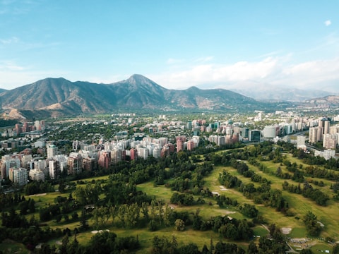city buildings on green grass field during daytime