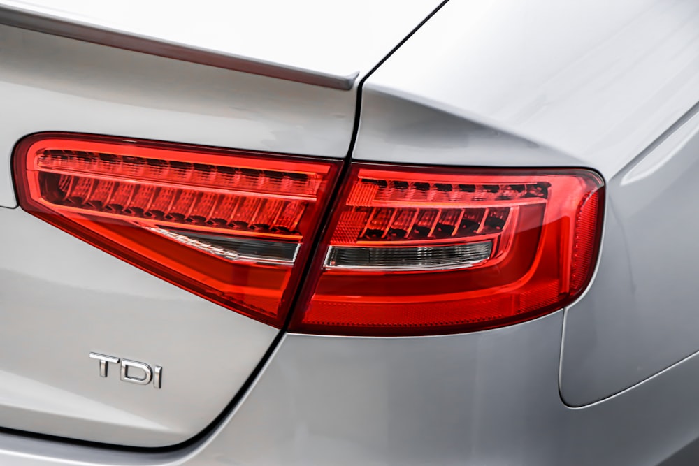 silver and red car with white background