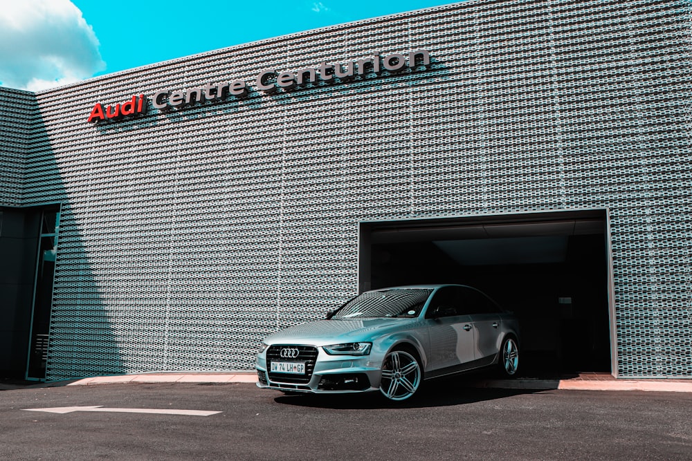 silver mercedes benz coupe parked beside gray concrete wall