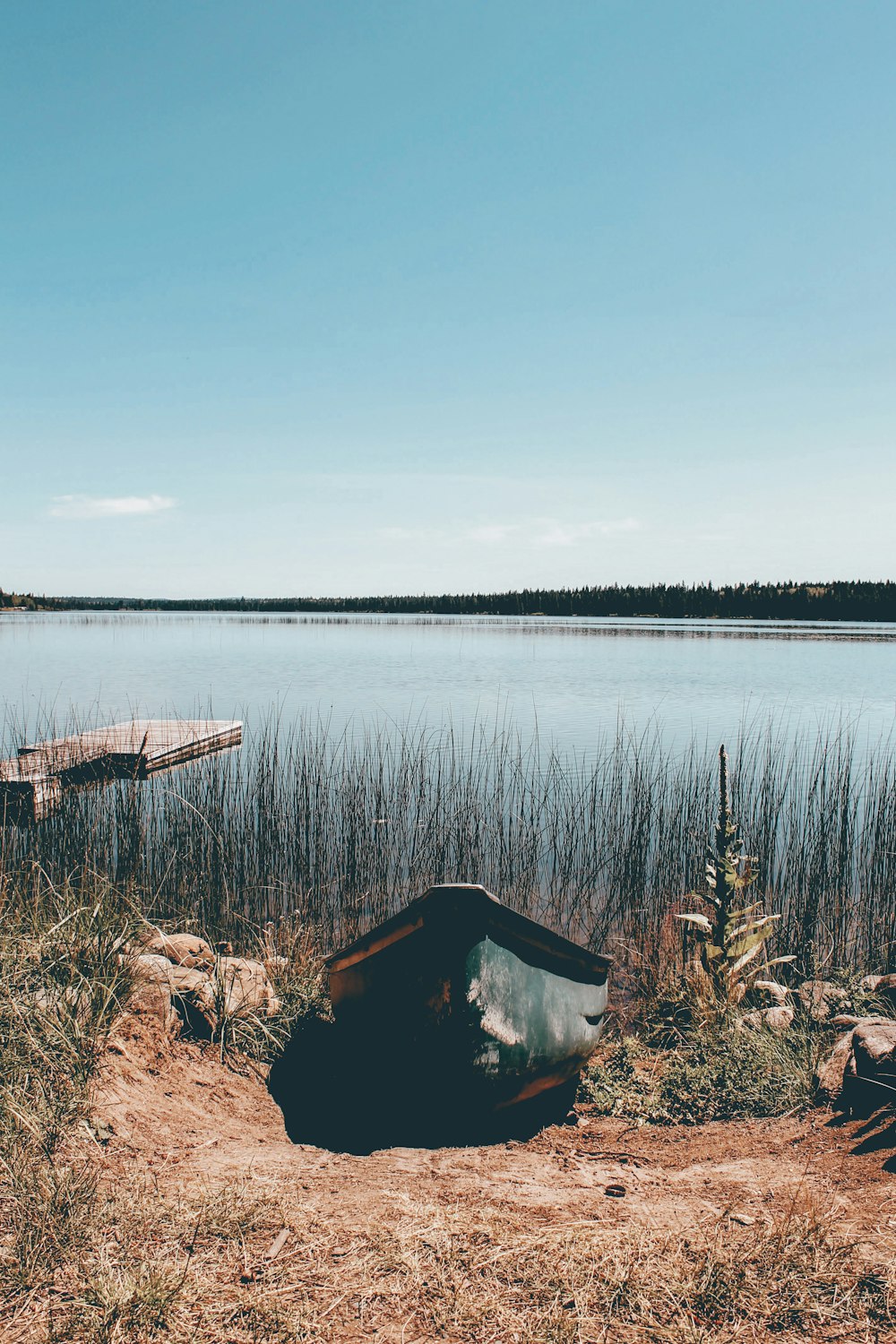 brown wooden boat on lake during daytime