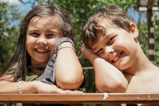 girl in gray sleeveless shirt smiling beside girl in gray sleeveless shirt