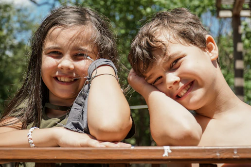 girl in gray sleeveless shirt smiling beside girl in gray sleeveless shirt