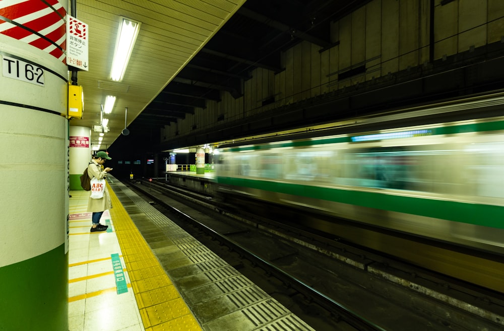 white and green train in train station