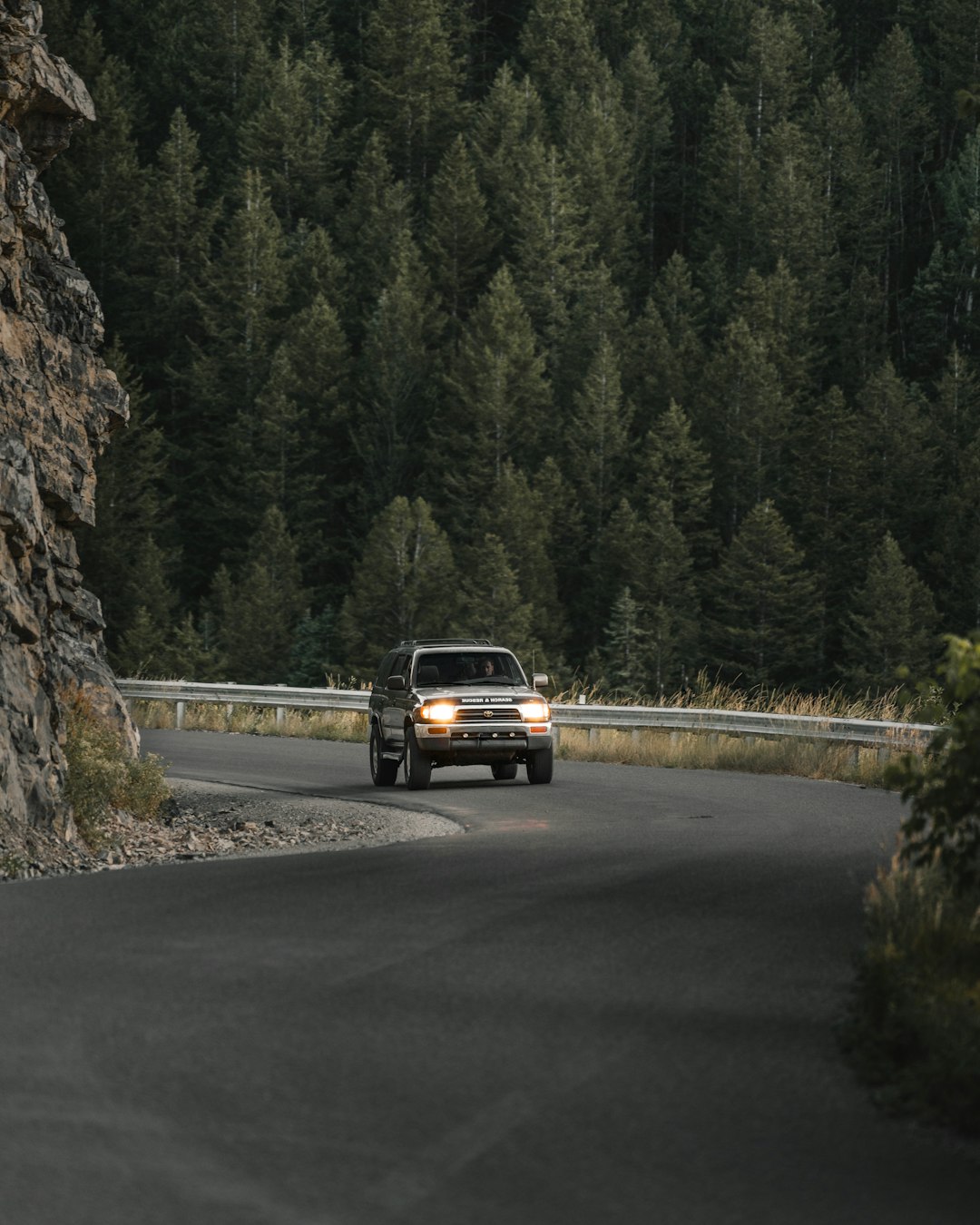 black suv on road near trees during daytime