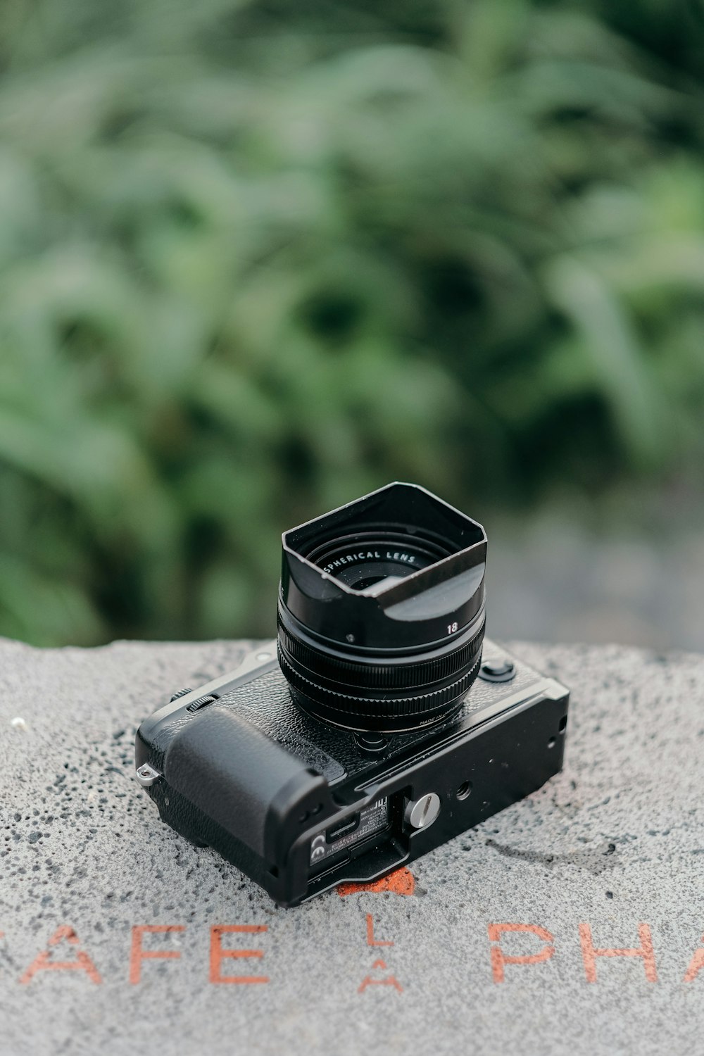 black camera lens on gray concrete surface