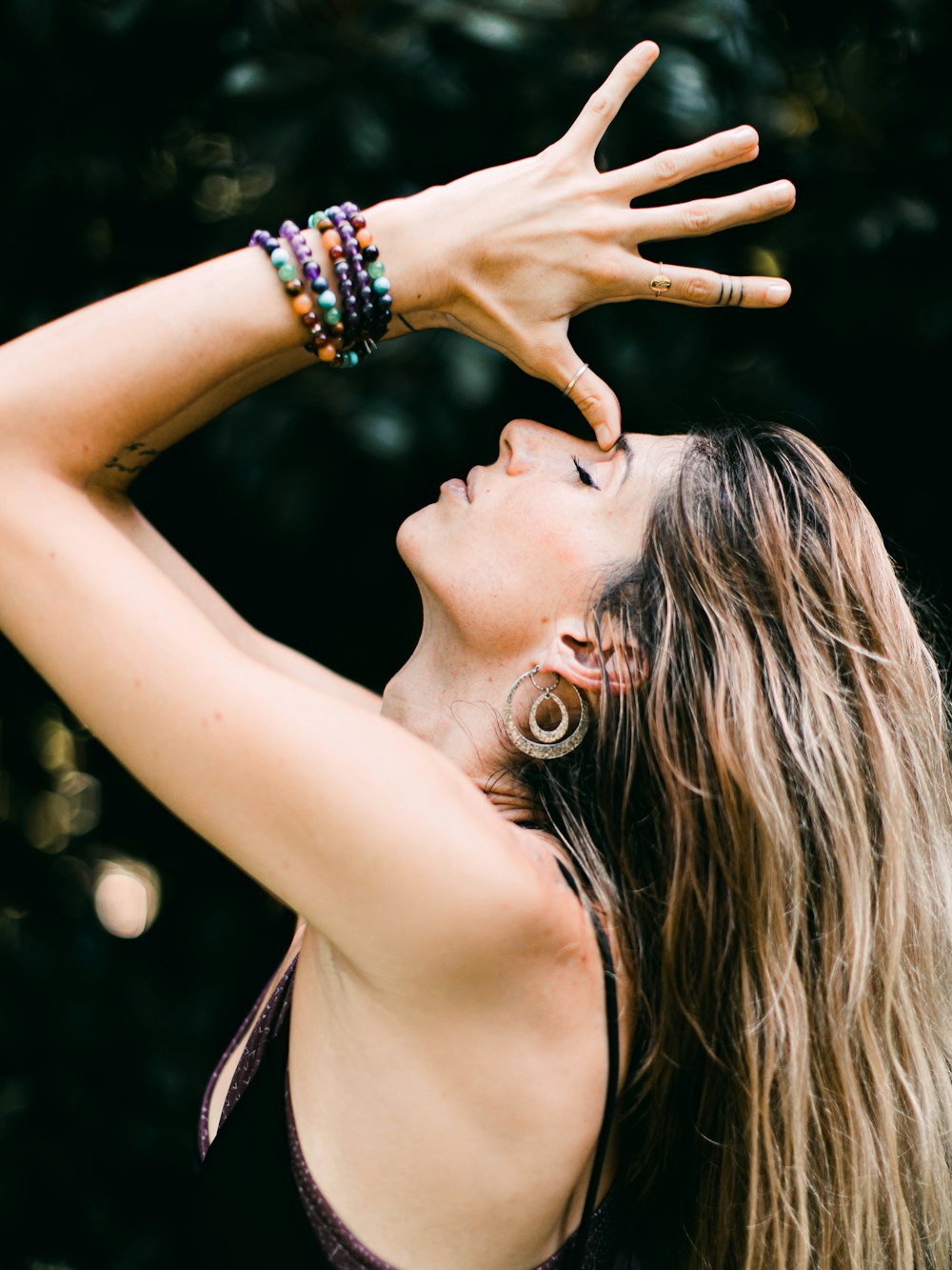 Mujer con camiseta sin mangas negra con pulsera plateada