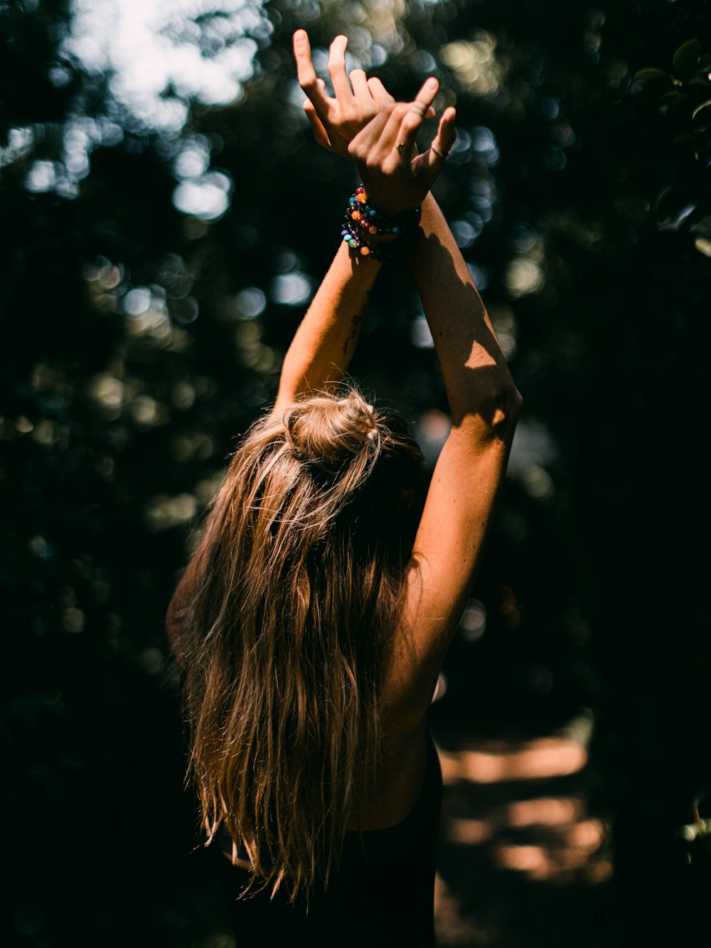 woman in black tank top with black tattoo on her left arm