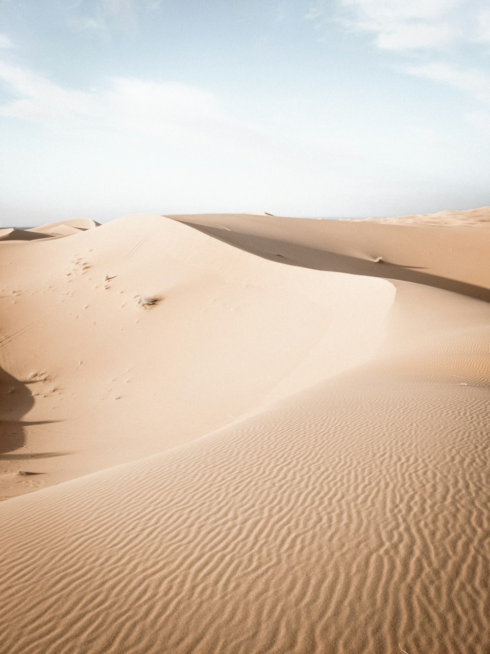 brown sand under blue sky during daytime