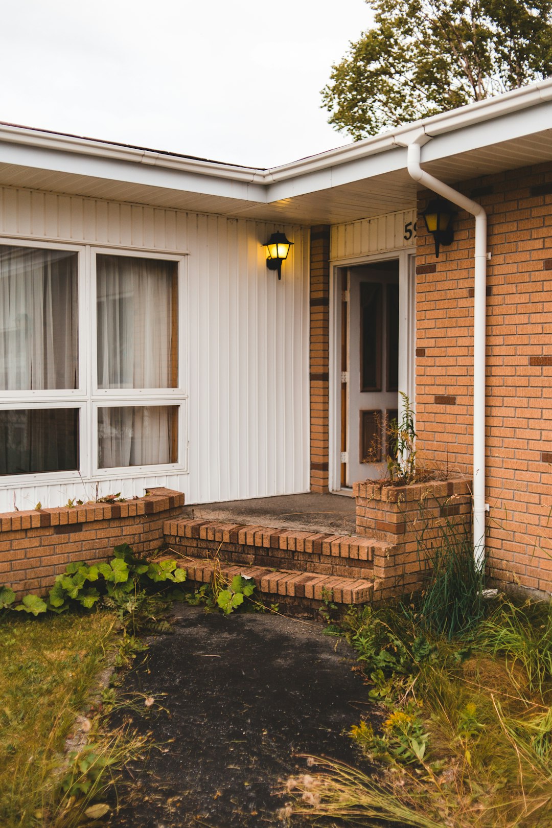 brown brick house with white wooden window