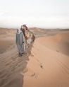 2 men walking on desert during daytime