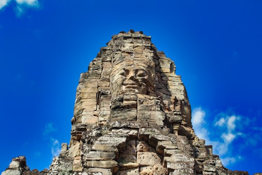 brown rock formation under blue sky during daytime in Angkor Thom Cambodia