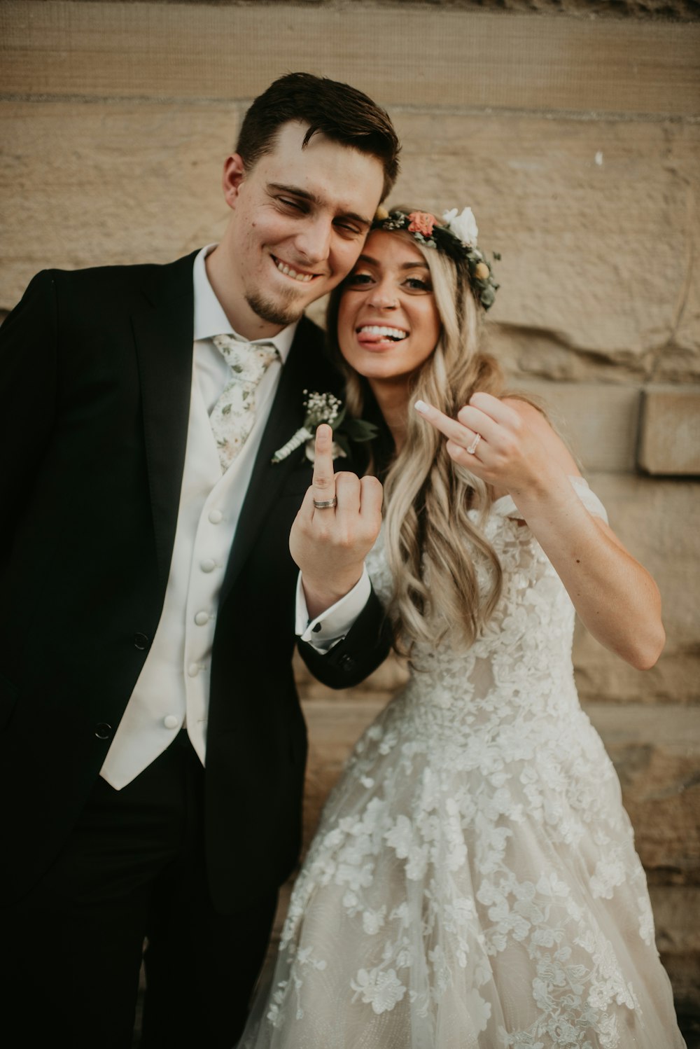 man in black suit and woman in white wedding dress