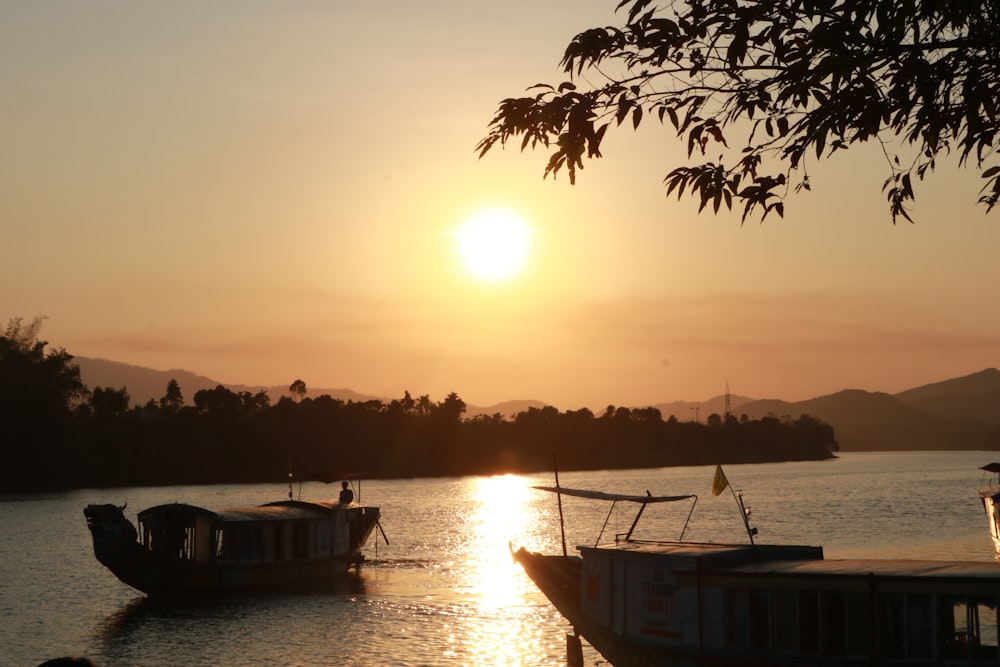 silhouette of boat on sea during sunset