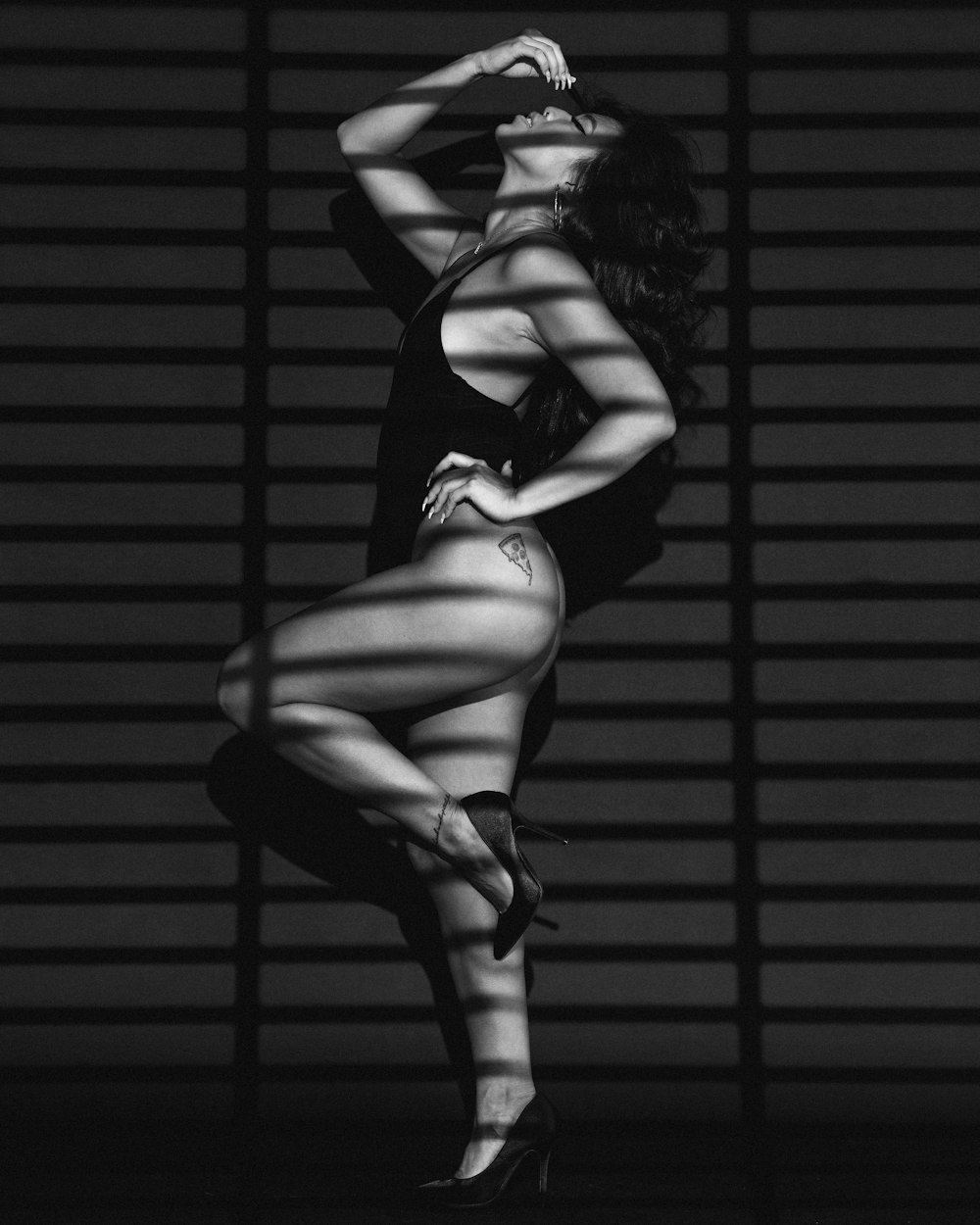 woman in black lingerie standing on black and white photography