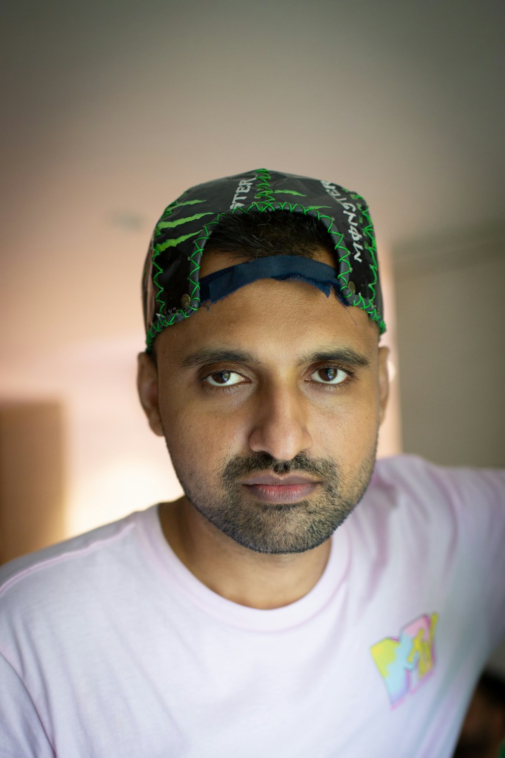 man in white crew neck shirt wearing green and black bandana