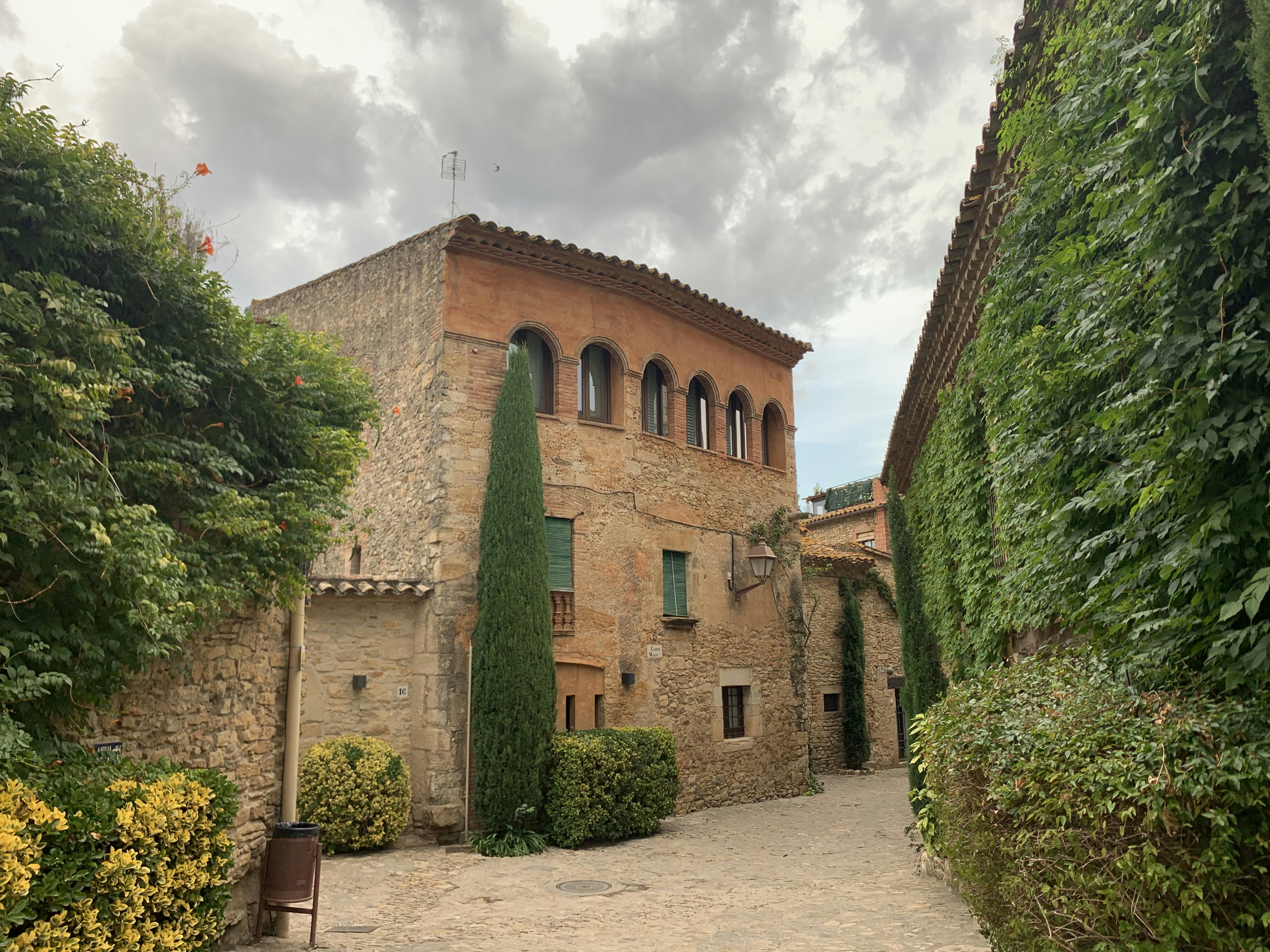 brown concrete building near green trees during daytime
