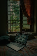 Guest using a laptop comfortably in a modern, cozy room with natural light.