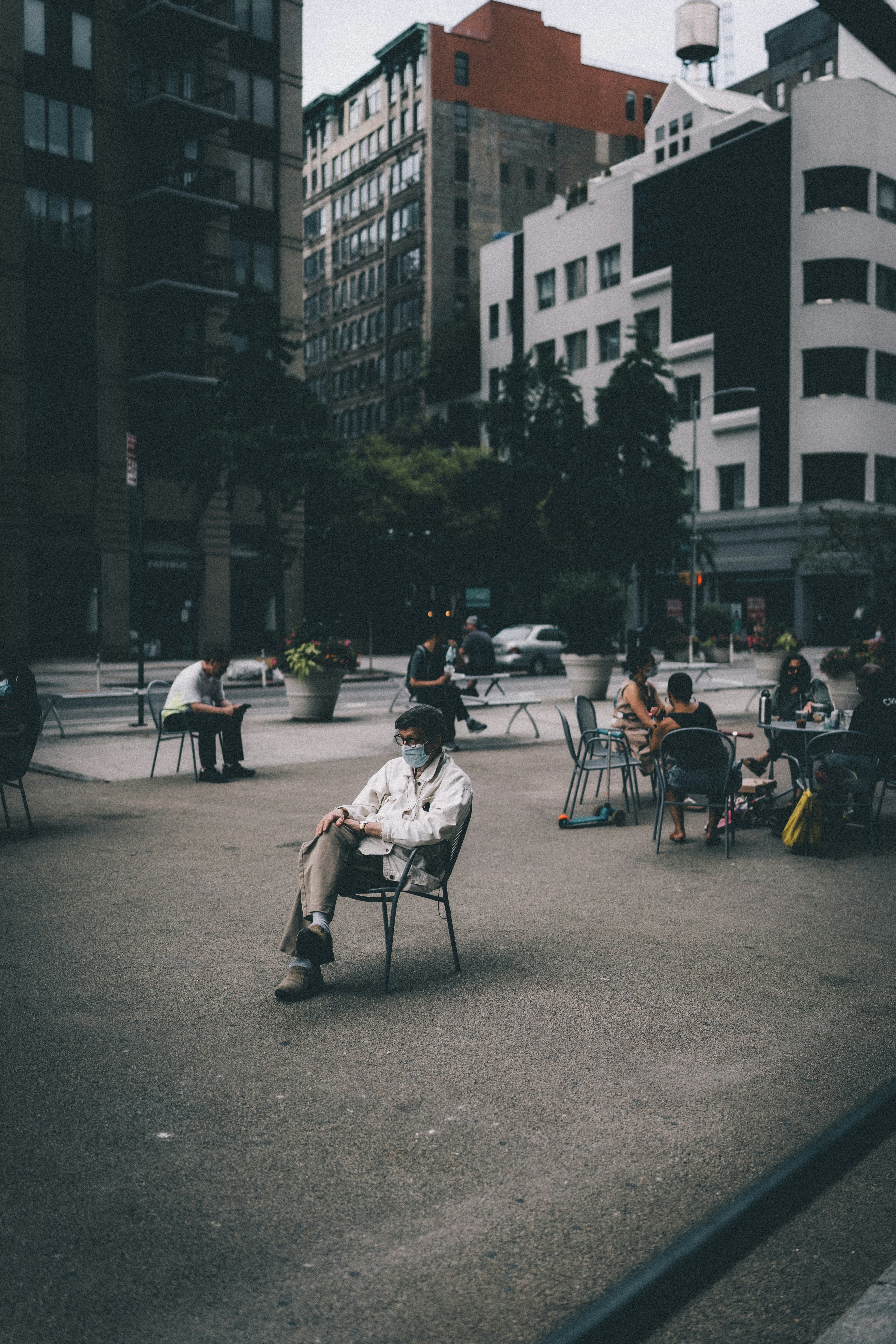 people sitting on chair near building during daytime