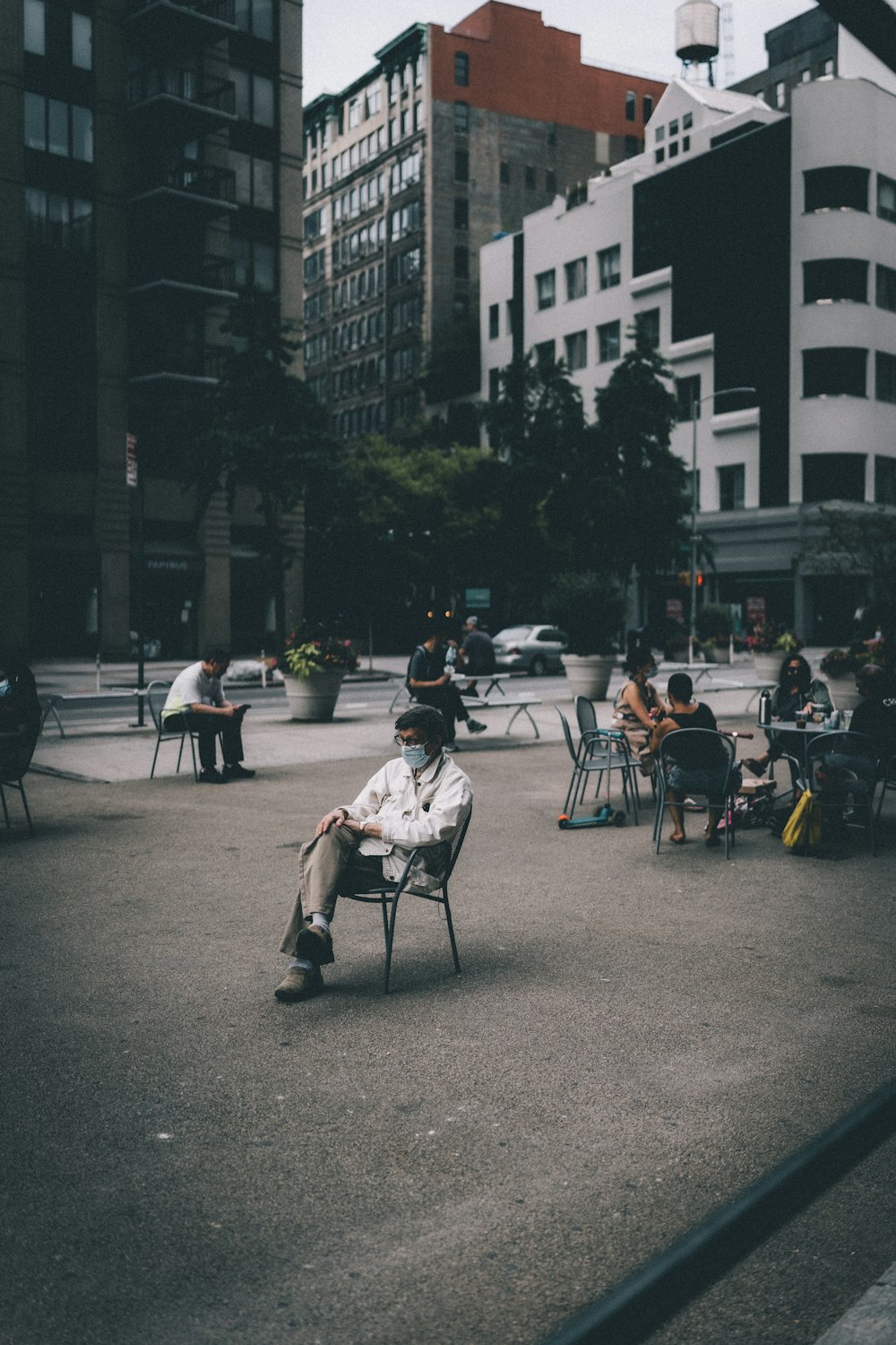 people sitting on chair near building during daytime