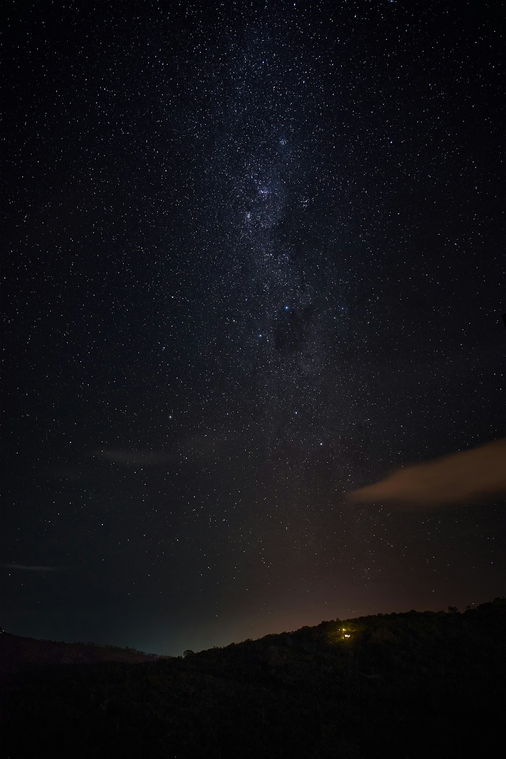 silhouette of mountain under starry night