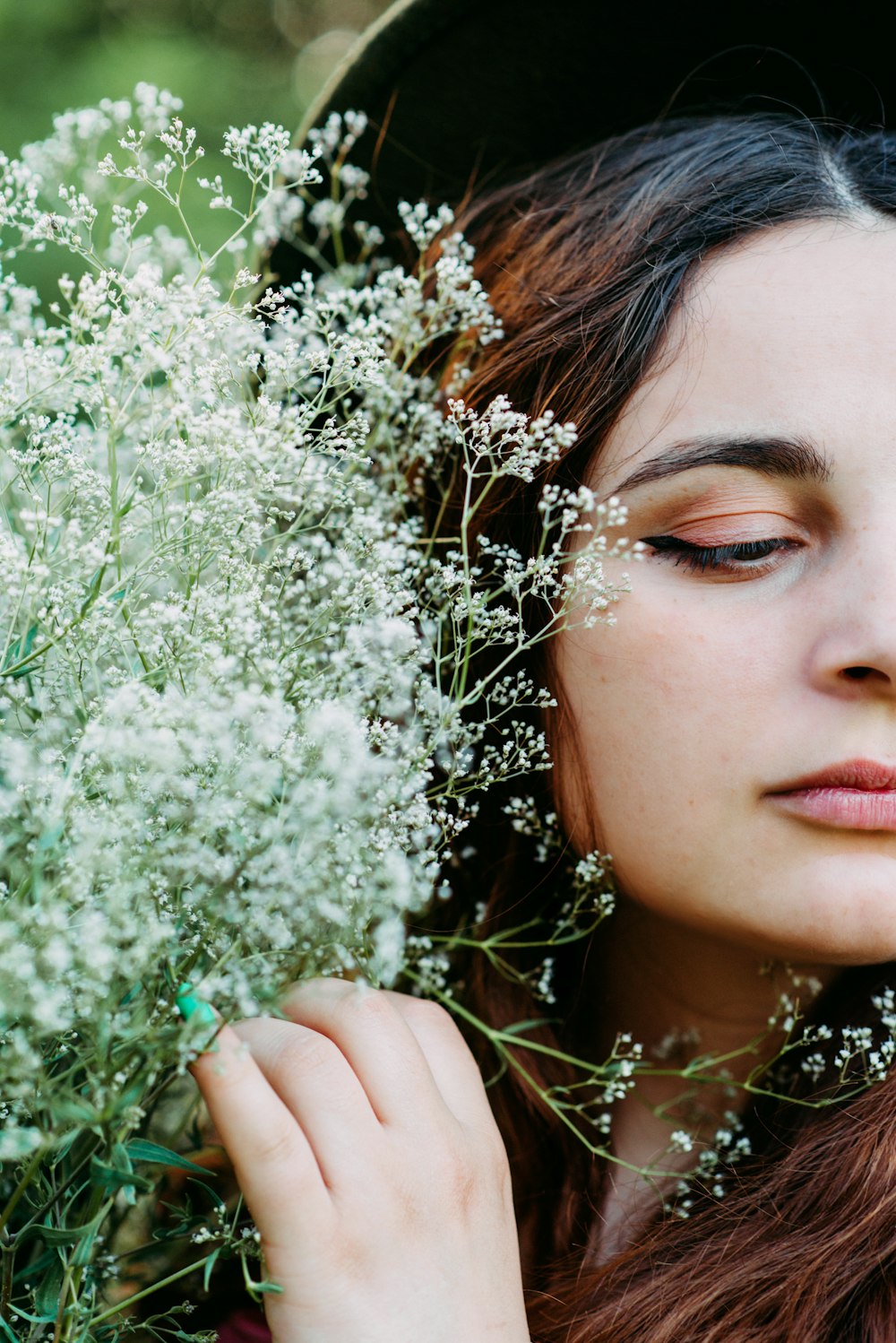 woman with white flower on her ear