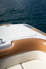 white and brown boat on water during daytime