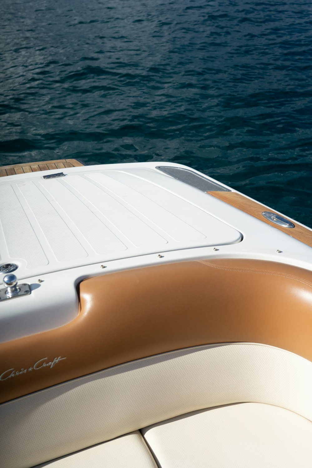 white and brown boat on water during daytime