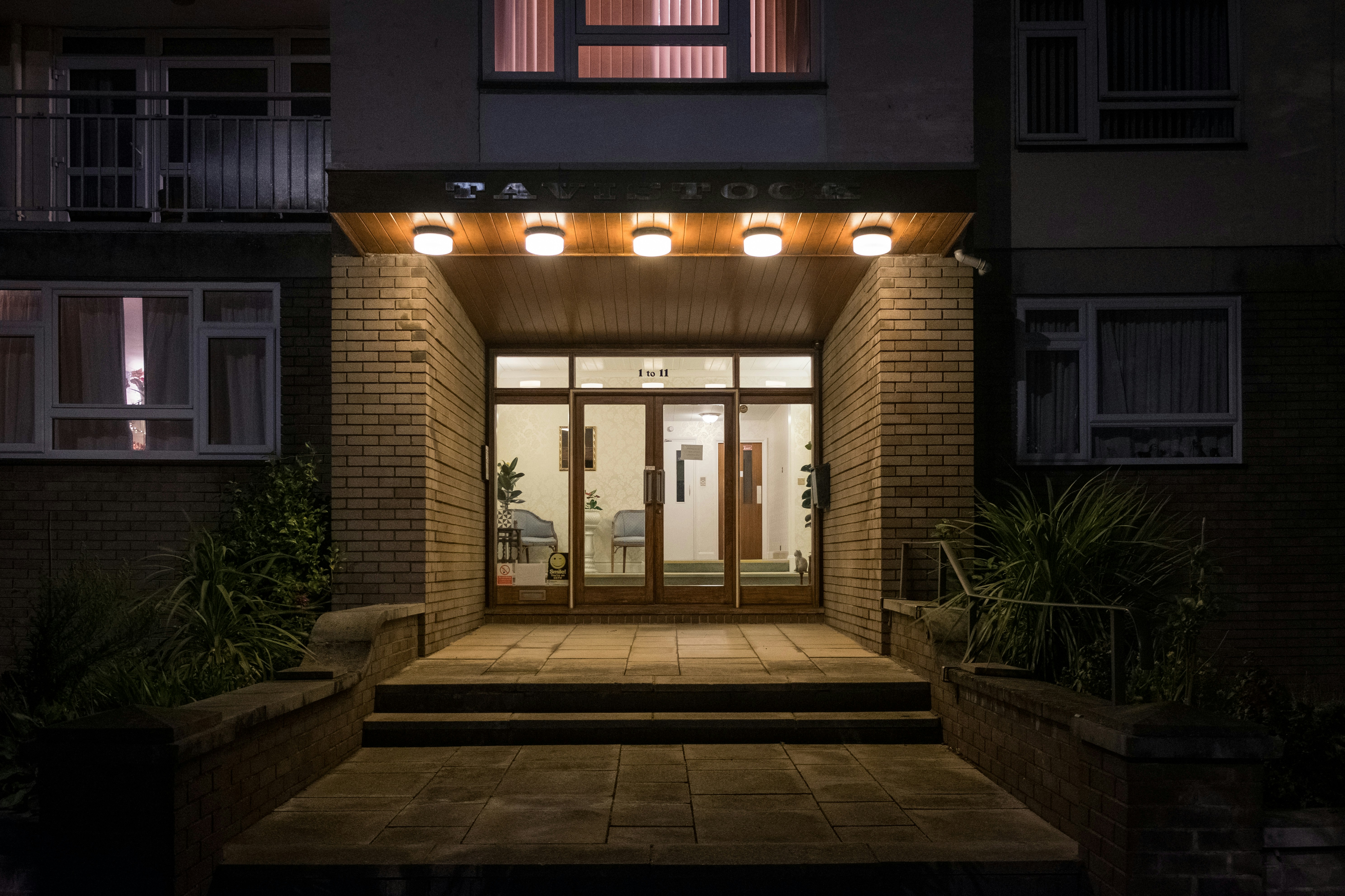 completed project, showing the new light fixture illuminated and enhancing the home's curb appeal - replacing outdoor light fixture