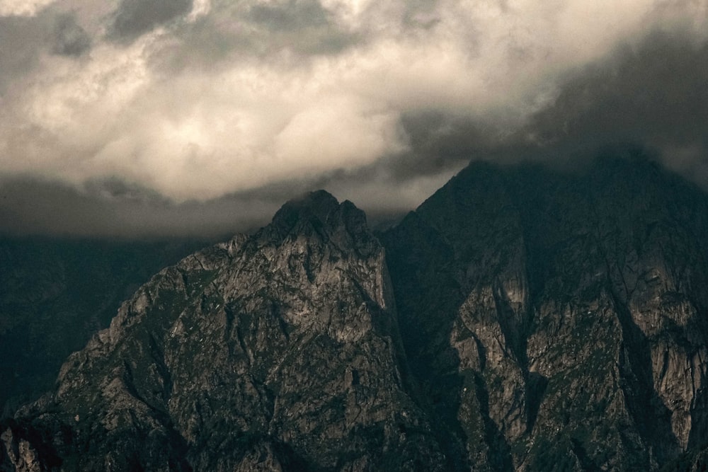 gray and black mountain under gray clouds