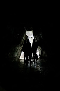 2 men in cave during daytime