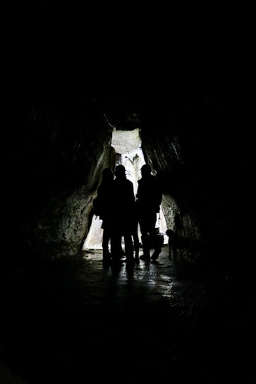 2 men in cave during daytime