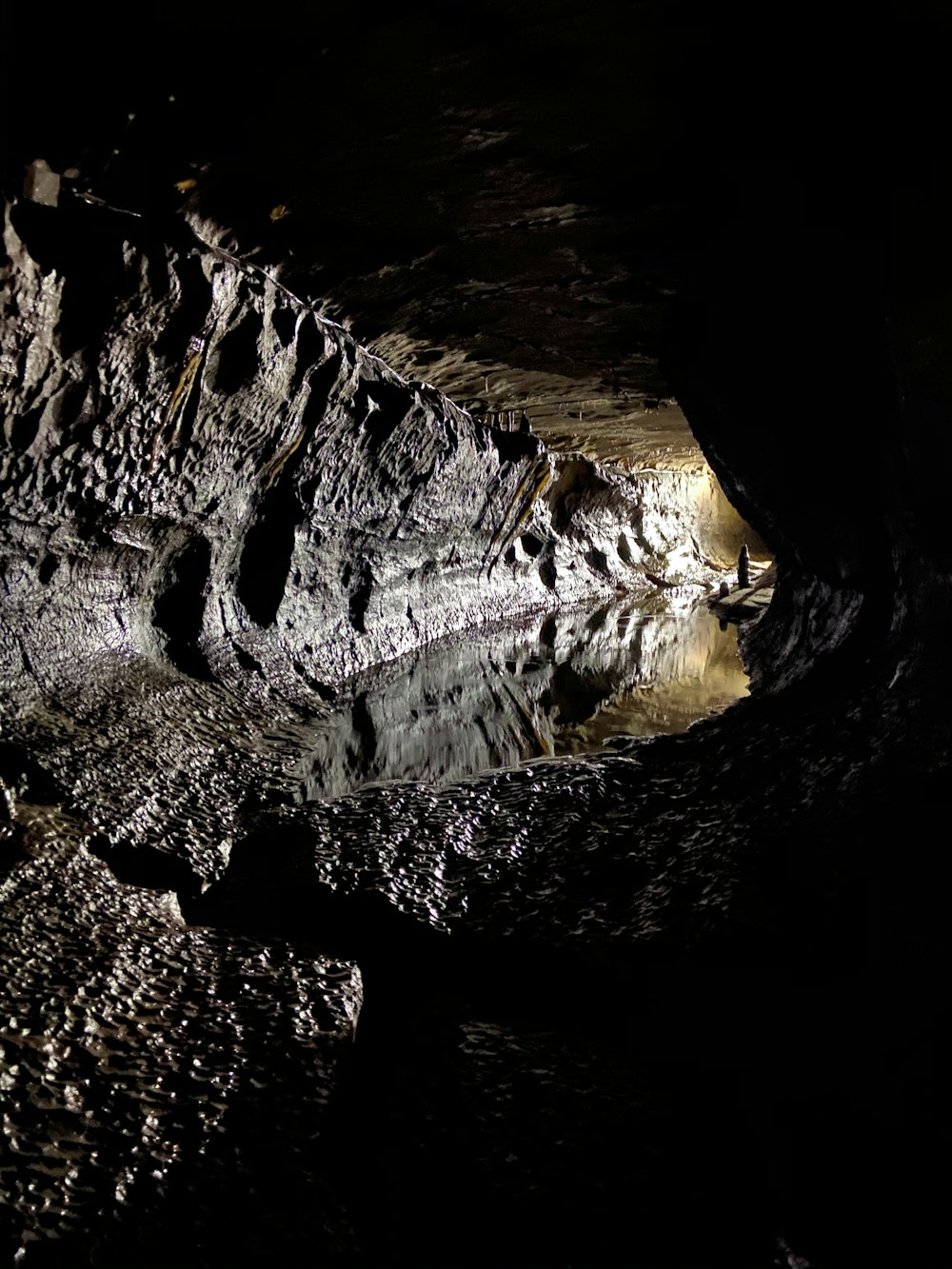 water falls in cave during daytime