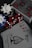 A collection of poker chips, red dice, and a deck of playing cards is arranged on a dark surface. The cards include an ace of spades with intricate black artwork and a standard Bicycle design. The set includes black, white, and blue poker chips featuring the Bicycle brand name.