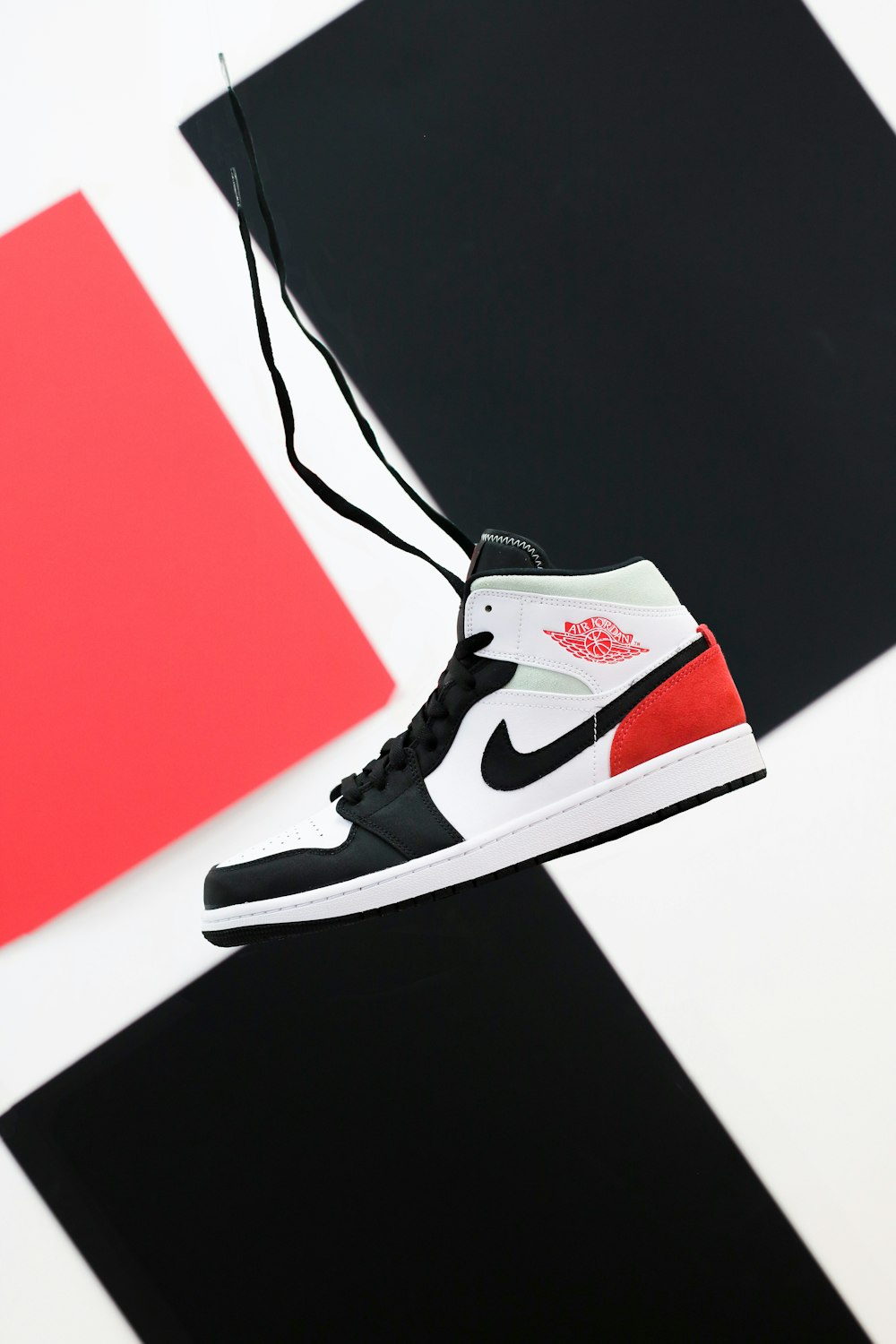 black white and red nike high top sneaker