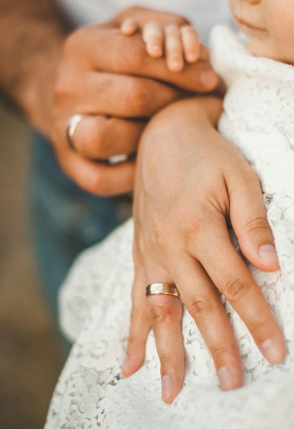 woman in white lace dress wearing gold ring