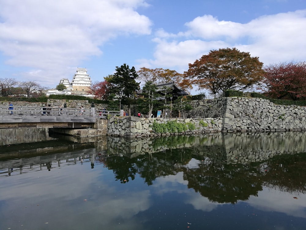 white concrete building near body of water under blue sky during daytime