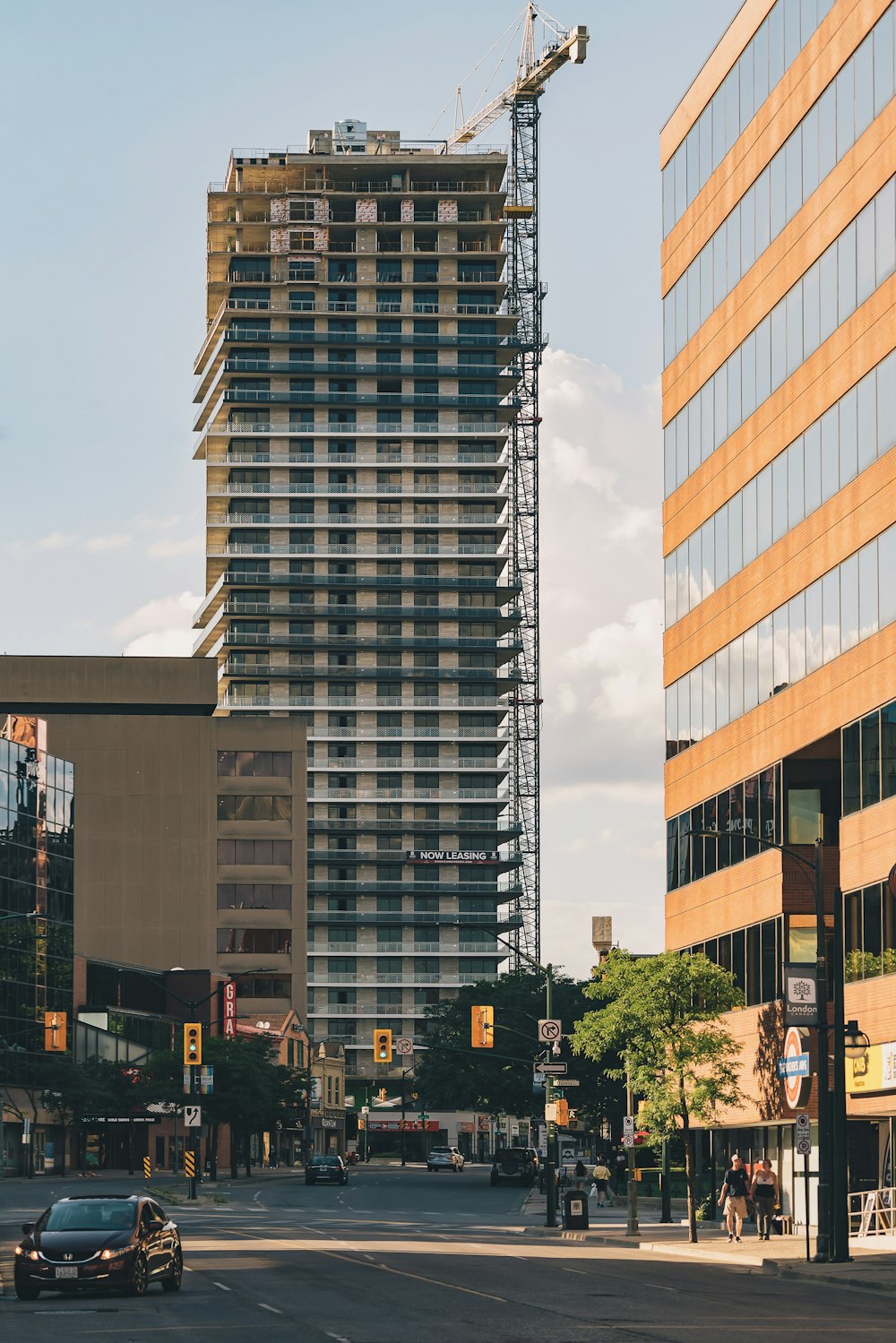 cars on road near high rise building during daytime