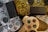 A collection of three gaming controllers with distinct designs and colors. The designs feature translucent materials and unique button symbols. The controllers are intricately arranged, showcasing various textures and materials.