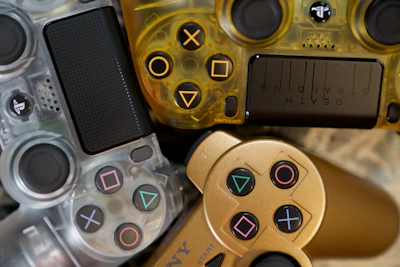 A collection of vibrant game controllers arranged on a black surface