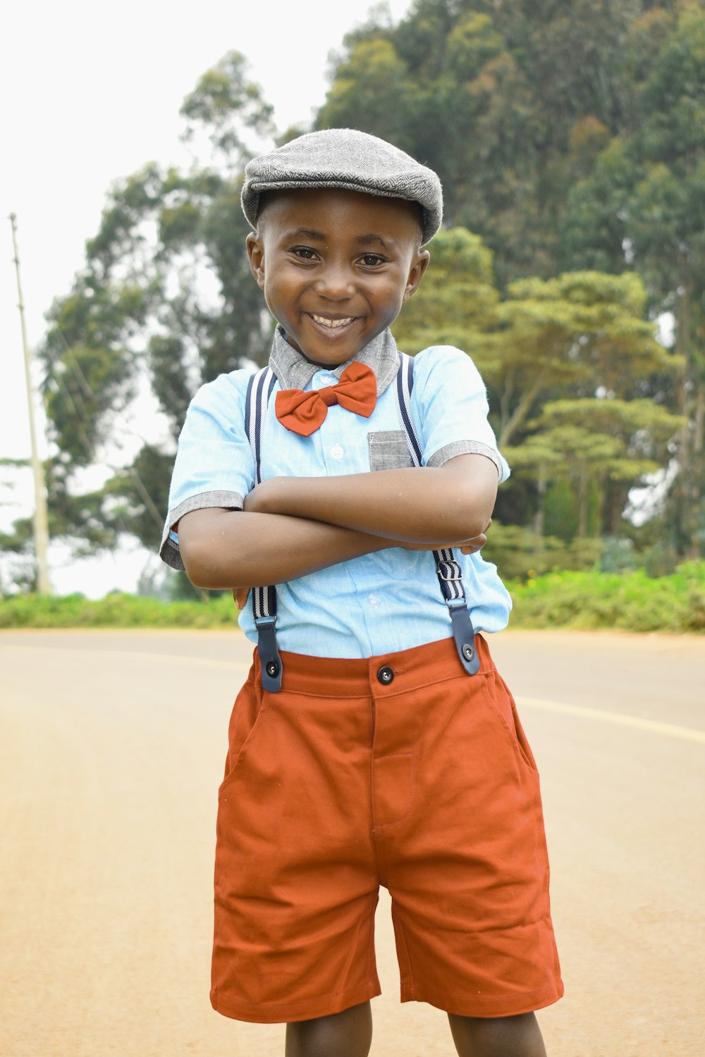 boy in orange shorts wearing black hat