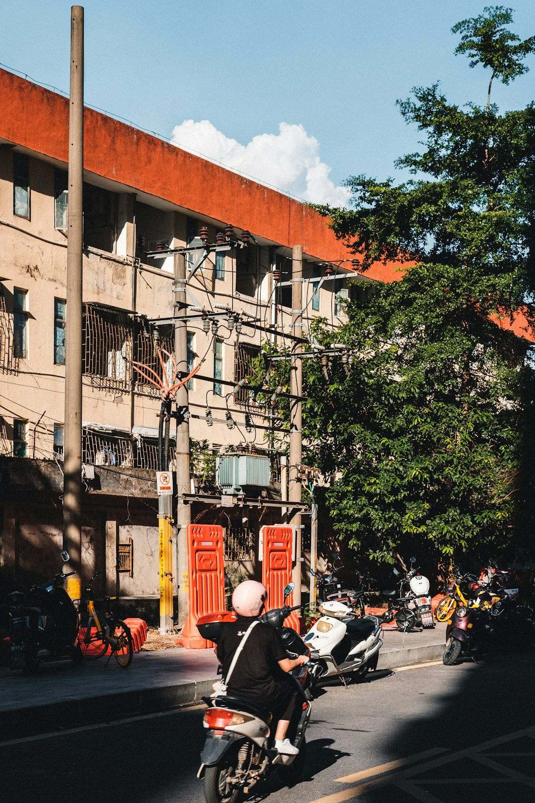 cars parked on side of the road near building during daytime