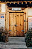 Welcoming entrance of Nivasara guest house with rustic wooden doors.